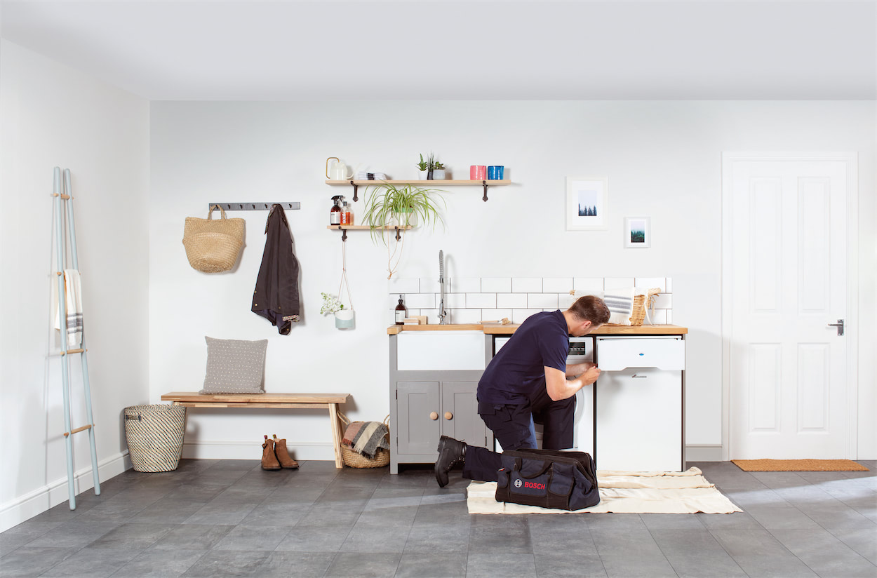 Technician working on white good appliance