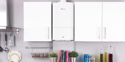 Photo of a boiler between a row of kitchen cabinets