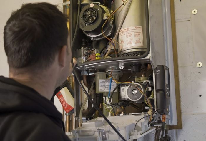 Photo of technician maintaining a boiler